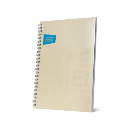 beige notebook with atlas copco logo and brand promise in beige embossed text